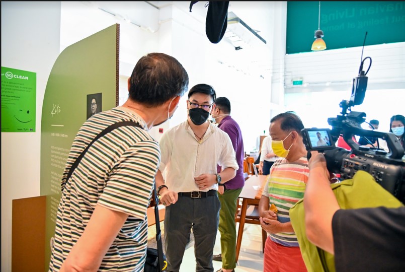 Brickland resident Eric Choong (in colourful striped shirt) with Ngee Polytechnic student Samuel Tan (in white shirt) checking out the exhibition.