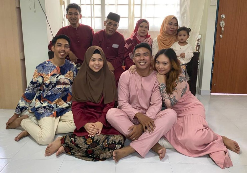 Keat Hong resident Noridah binte Othman (back row, second from right) with her husband, Kamari bin Muhali (on her right) having a small celebration last year with only immediate family members. Front row, from left are the couple’s second son, Muhd Hamiyadiy bin Kamari, third daughter, NurHanis Hanani binte Kamari, eldest son, Muhd Hamizan bin Kamari, and his wife, Nordiana binte Ibrahim. Back row, from left are their fourth son, Muhd Hamizharif bin Kamari, and wife of their second son, Siti Hadeejah binte Abd Rahman, holding her daughter, Aara Basyirah binte Muhd Hamiyadiy.