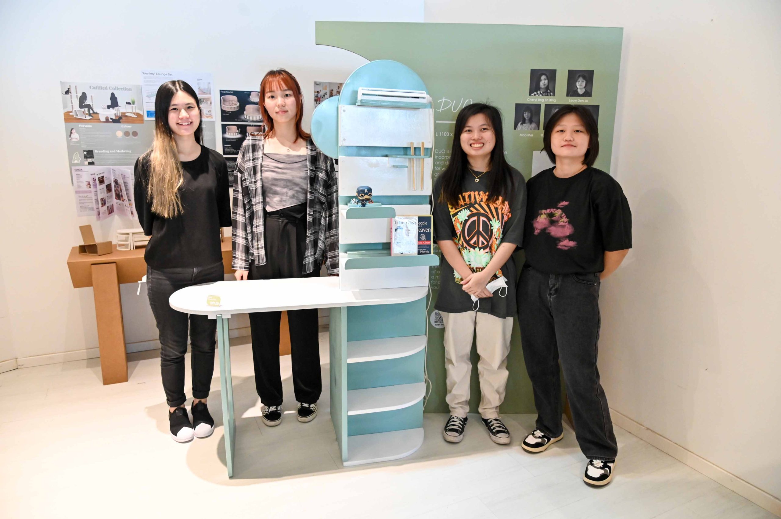 (From left) Teo Zu Er, Mao Mei, Cheryl Ling and Leow Den Jo, four of the five creators posing with DUO, a desk-cum-shelf which incorporated parts of resident Eric Choong’s mahogany cabinet.
