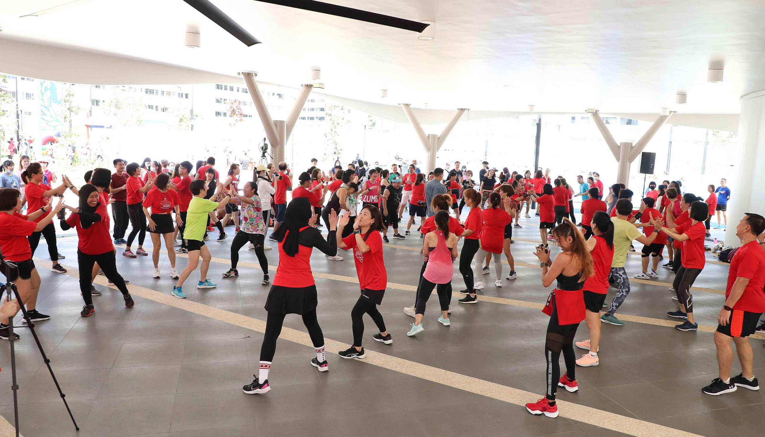 Residents enjoying Zumba under the covered event hall, one of the many features and amenities at The Arena @ Keat Hong.